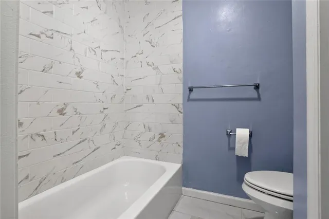 a bathroom with a toilet and a bathtub