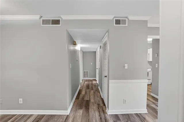 a view of a hallway with wooden floor