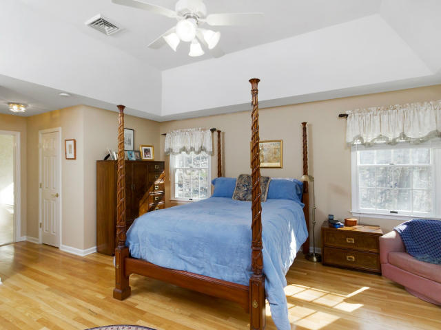 151 Ledges Road Ridgefield, CT 06877 - Photo 12 of 24 a bed room with furniture and a chandelier