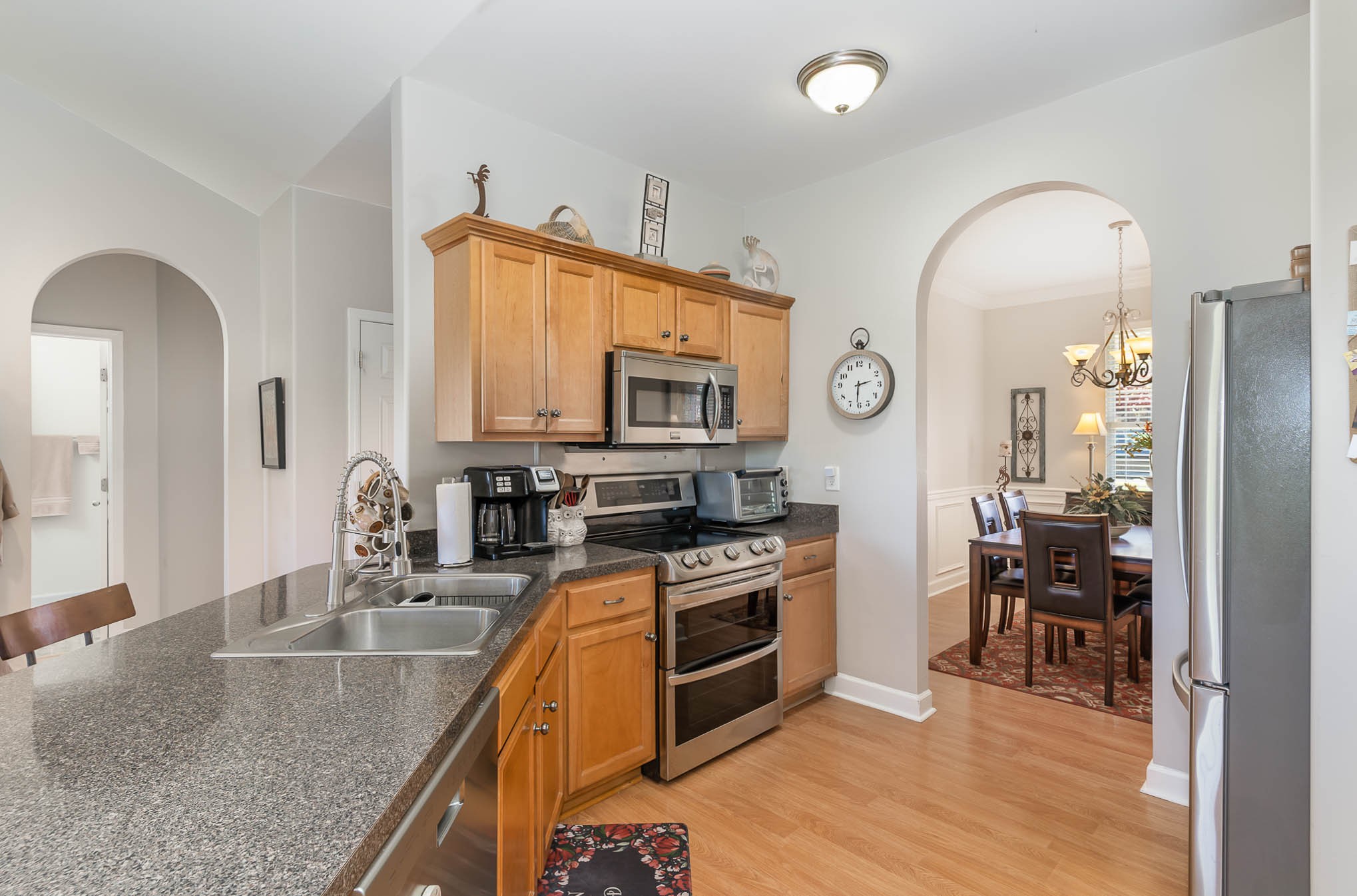 2010 Sunflower Drive Spring Hill, TN 37174 - Photo 4 of 20 a kitchen with stainless steel appliances granite countertop a stove top oven a sink dishwasher a dining table and chairs with wooden floor
