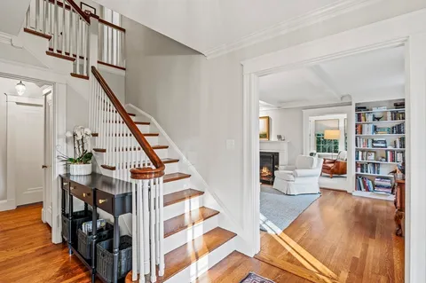 a living room with furniture and stairs