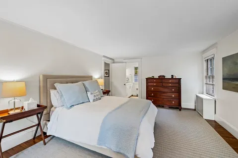 a bedroom with a bed and dresser