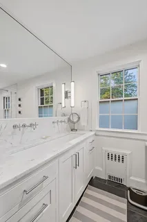 a spacious bathroom with a sink and a window