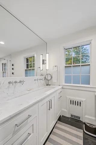a spacious bathroom with a sink and a window