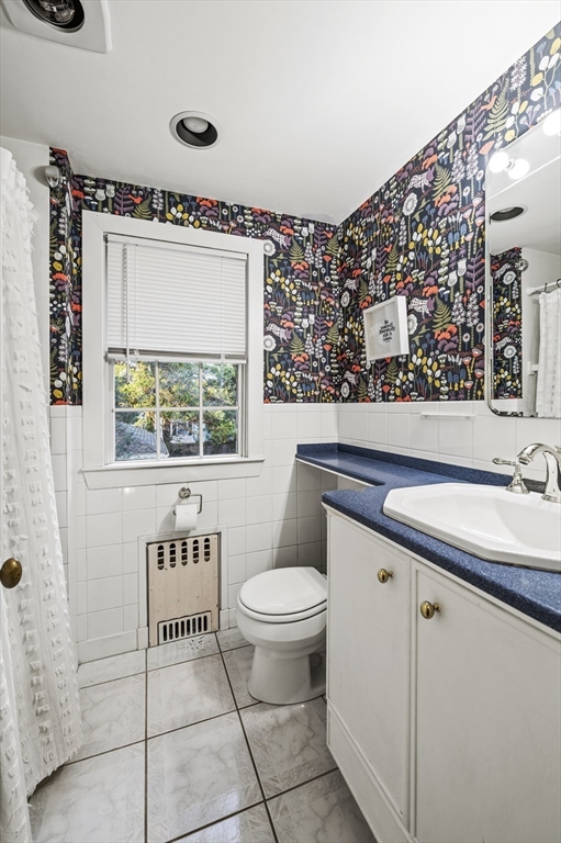 19 Elmwood Road Marblehead, MA 01945 - Photo 24 of 36 a bathroom with a toilet sink and mirror