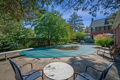 a view of backyard with seating area and trees