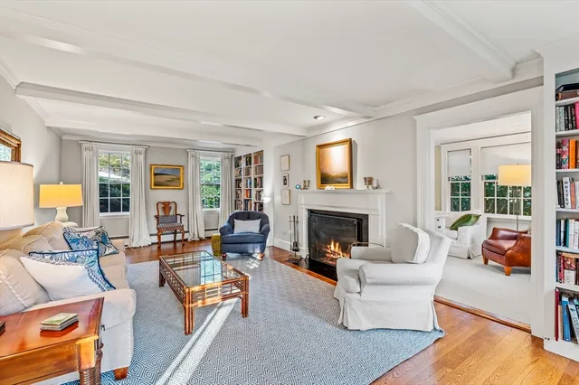 a living room with fireplace furniture and a large window