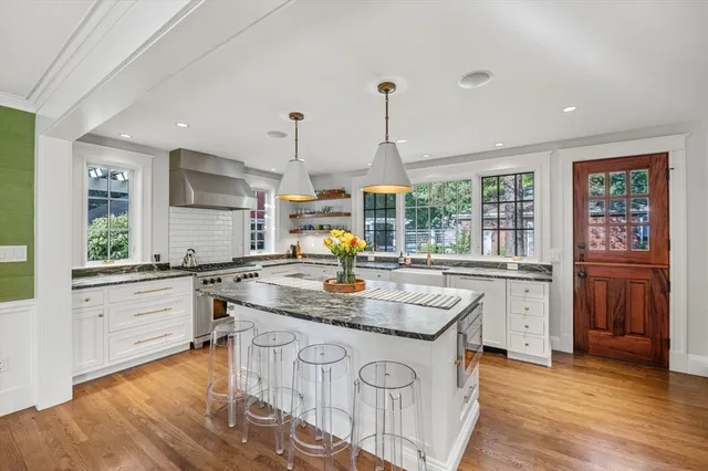 a kitchen with stainless steel appliances granite countertop a sink and stove