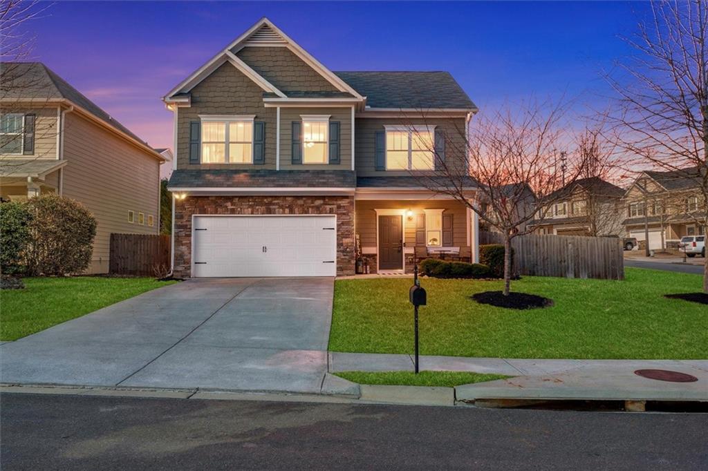 a front view of a house with a yard and garage
