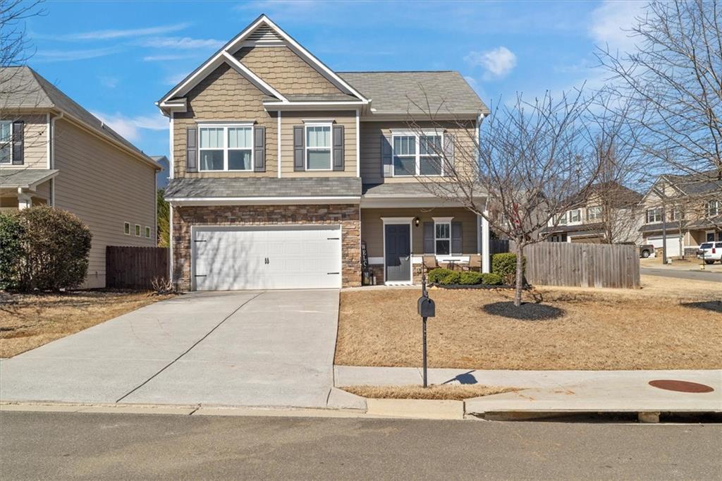 329 Rippling Drive Ball Ground, GA 30107 - Photo 2 of 43 a front view of a house with a yard and garage