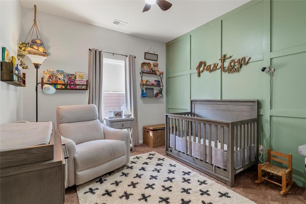 329 Rippling Drive Ball Ground, GA 30107 - Photo 23 of 43 a living room with furniture and a baby crib