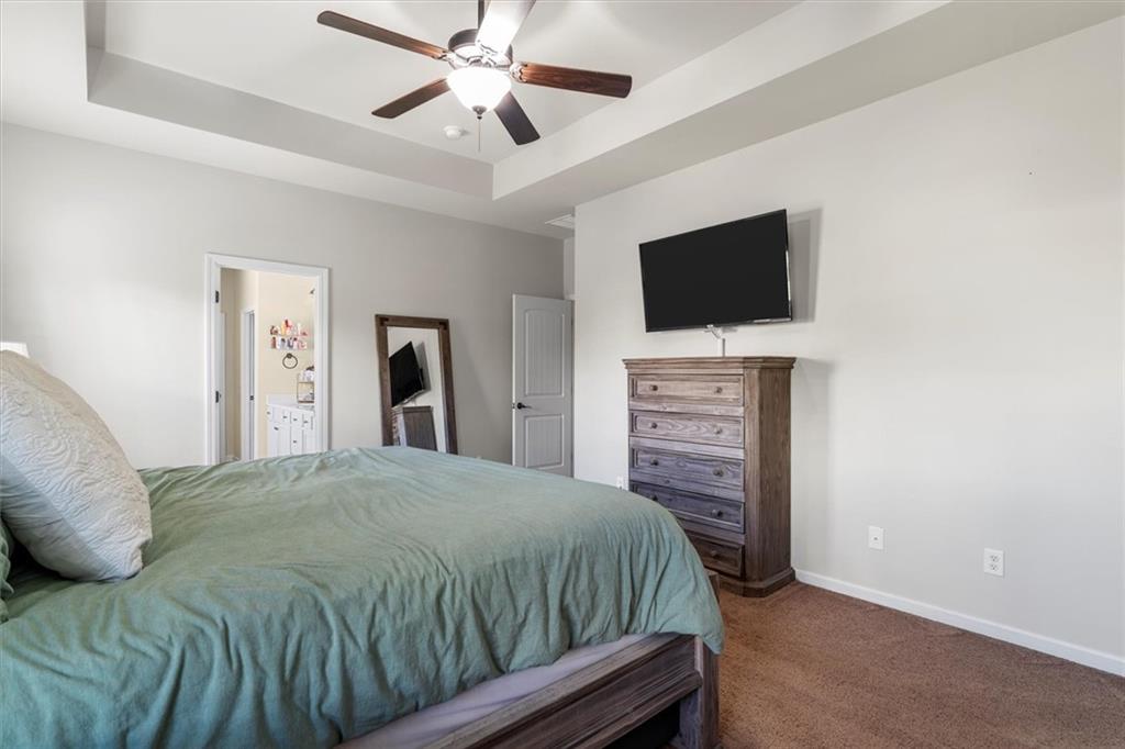 329 Rippling Drive Ball Ground, GA 30107 - Photo 25 of 43 a bedroom with a bed and a flat screen tv