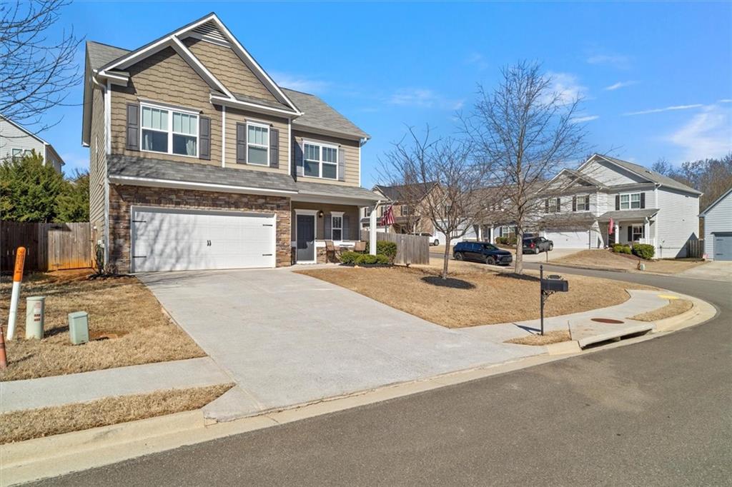 329 Rippling Drive Ball Ground, GA 30107 - Photo 3 of 43 a front view of a house with a yard