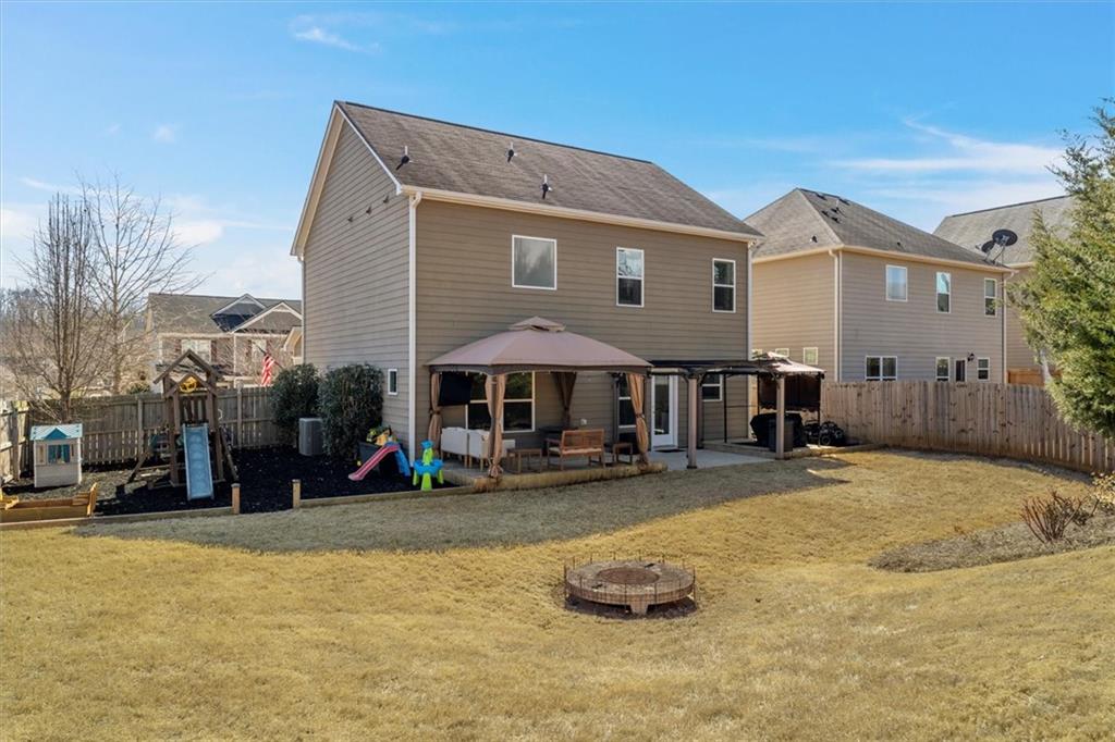 329 Rippling Drive Ball Ground, GA 30107 - Photo 34 of 43 a backyard of a house with barbeque oven table and chairs