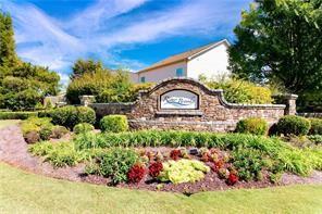 329 Rippling Drive Ball Ground, GA 30107 - Photo 37 of 43 a front view of a house with a yard garden and outdoor seating