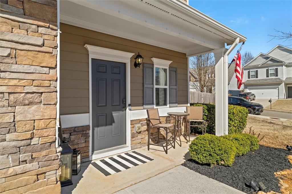 329 Rippling Drive Ball Ground, GA 30107 - Photo 5 of 43 front view of a house with a chairs and table in a patio