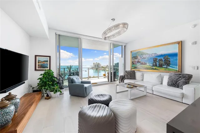 a bedroom with a bed large window with table and chair