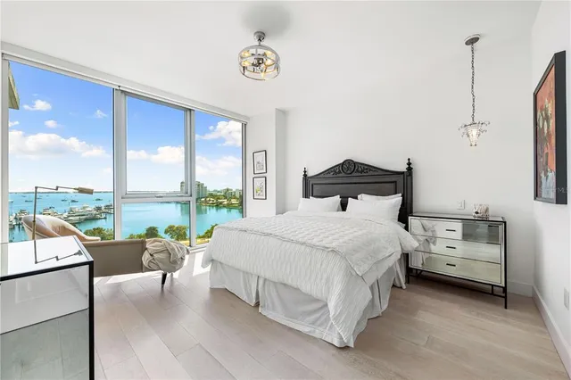 a bedroom with a bed and painting on the wall