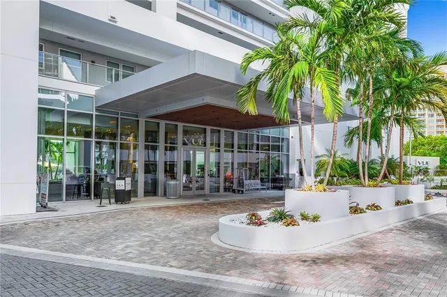 a kitchen with stainless steel appliances kitchen island granite countertop a refrigerator and microwave