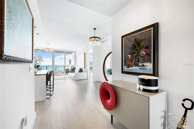 a large kitchen with stainless steel appliances granite countertop a stove a sink and a chandelier