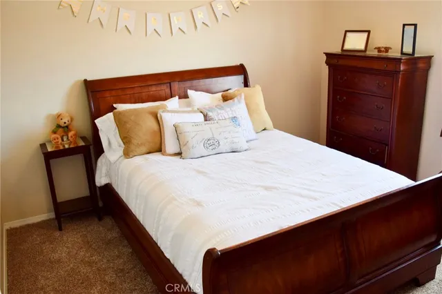 a bed sitting in a bedroom and dresser