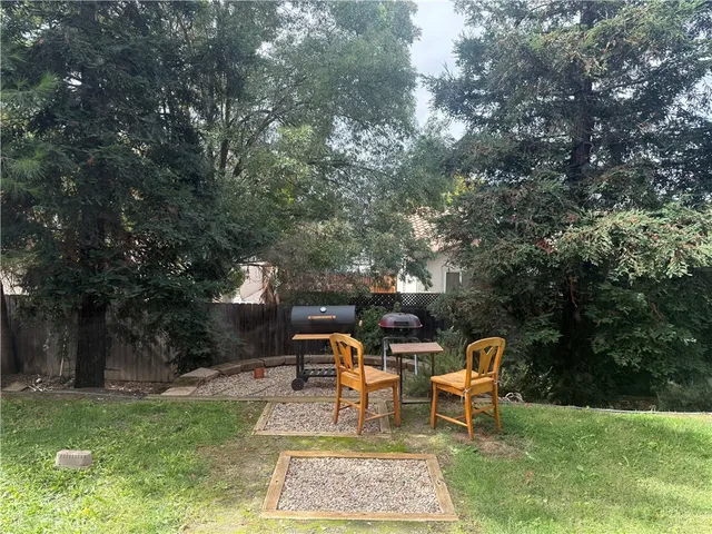 a backyard of a house with table and chairs
