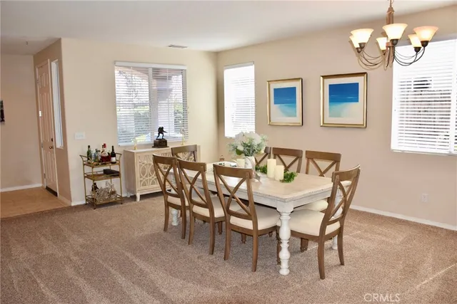 a dining room with furniture and window