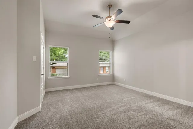 a view of empty room with ceiling fan