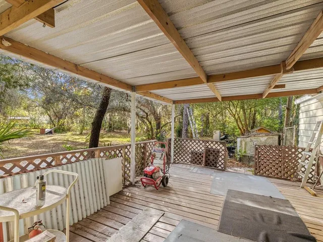 a front view of a house with a garden and tree