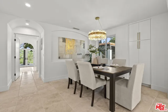 a view of a dining room with furniture and chandelier