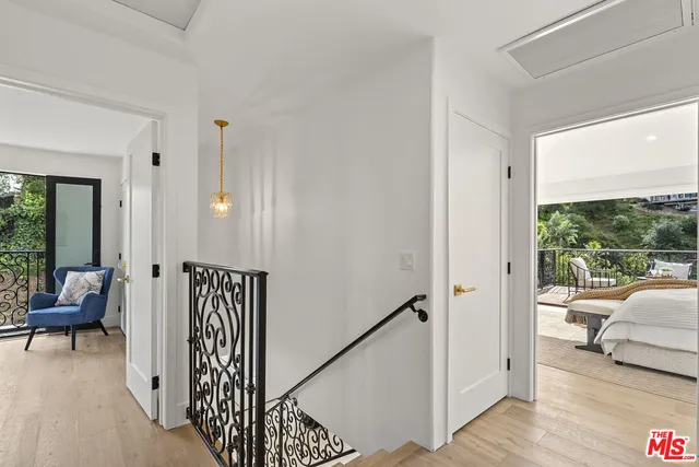 a bedroom with a bed and large windows