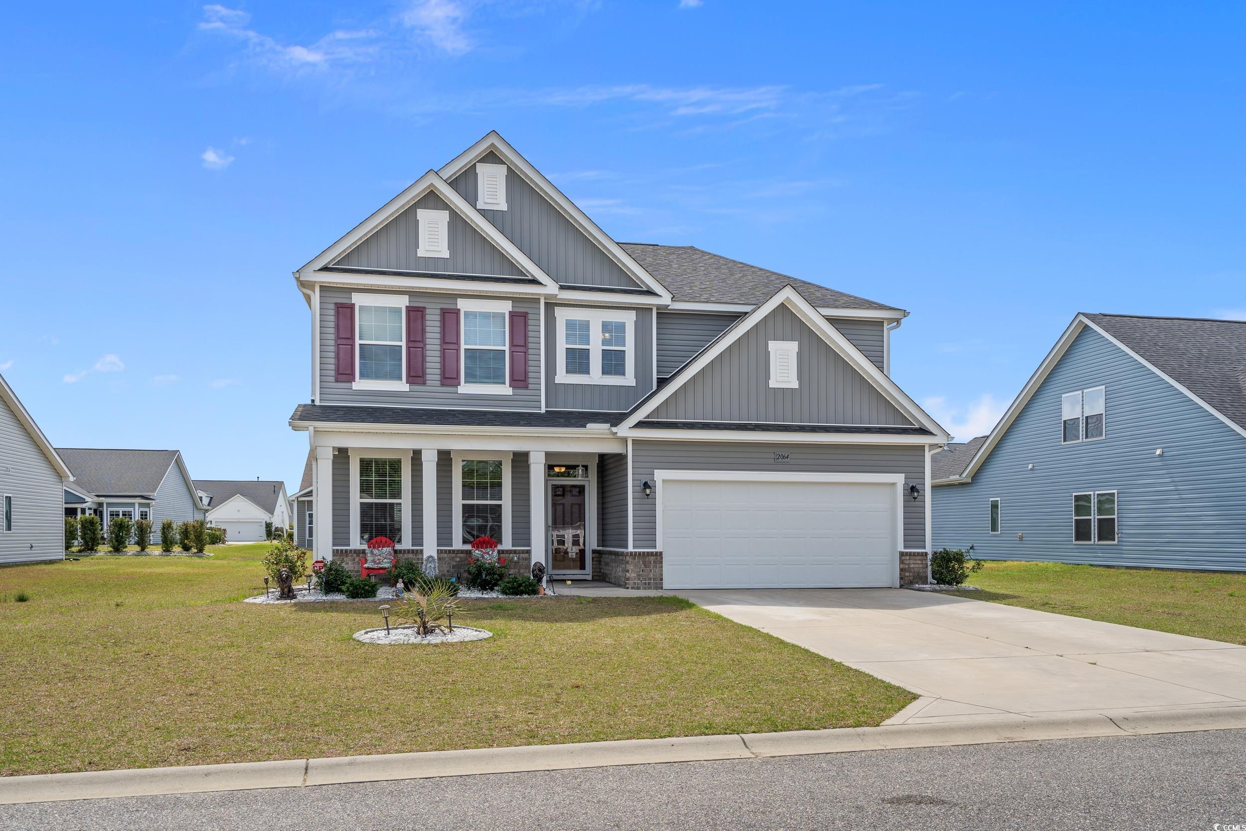 2064 Hazlette Loop Conway, SC 29526 - Photo 1 of 39 Craftsman-style house with a garage, concrete driveway, a front yard, board and batten siding, and covered porch