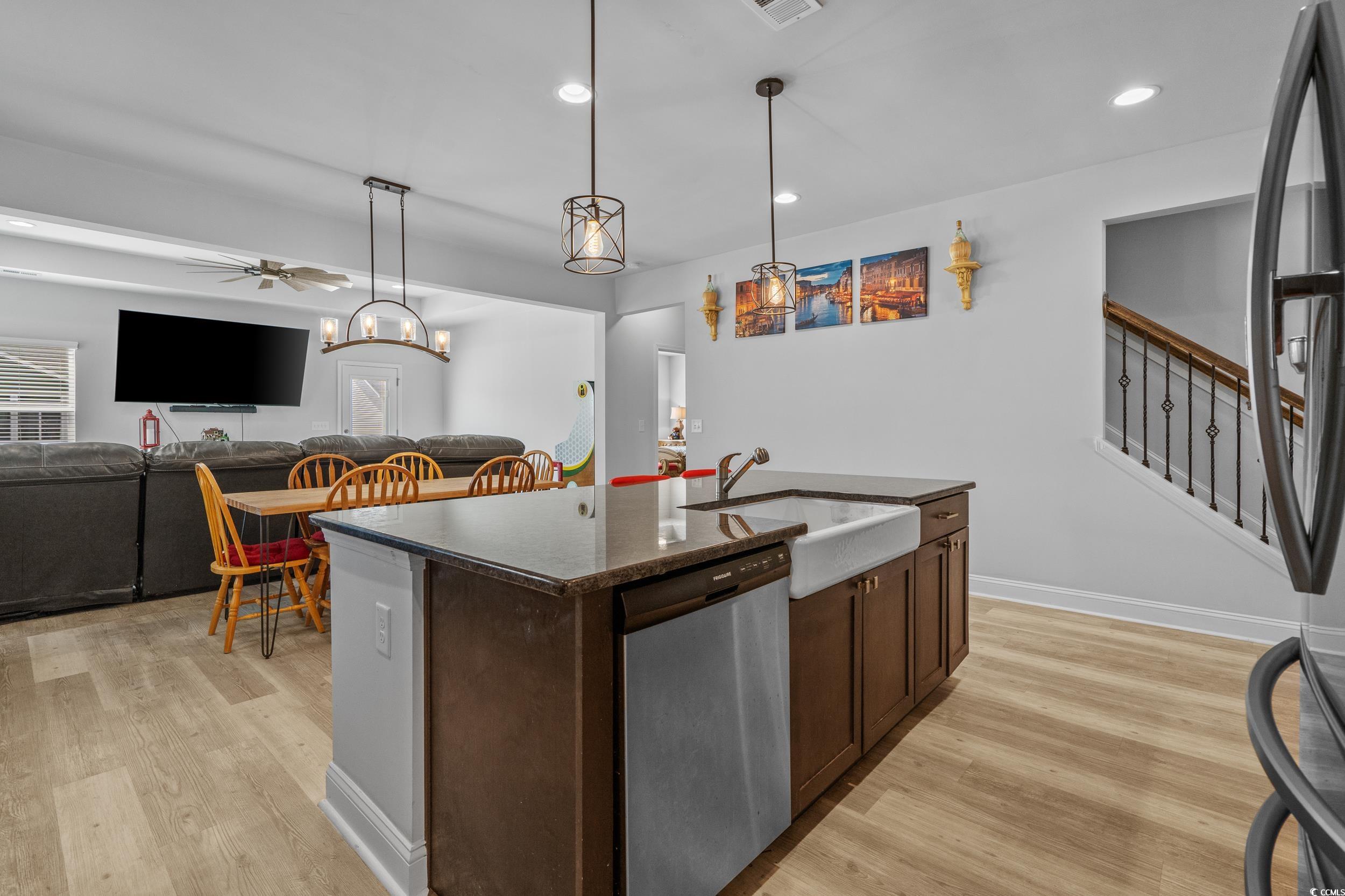 2064 Hazlette Loop Conway, SC 29526 - Photo 11 of 39 Kitchen with dishwasher, light wood-style flooring, a sink, and dark brown cabinetry