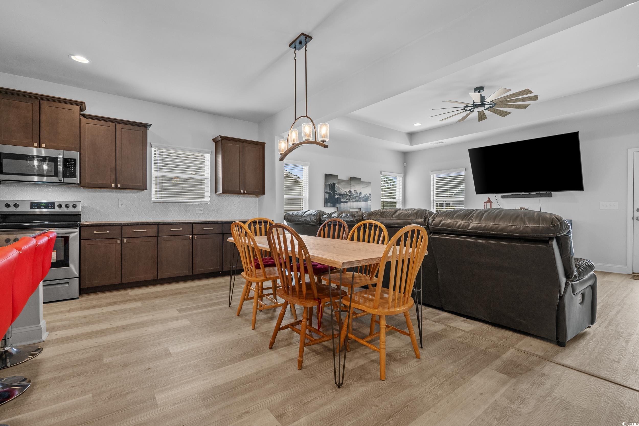 2064 Hazlette Loop Conway, SC 29526 - Photo 16 of 39 Dining room with light wood-style floors, a raised ceiling, recessed lighting, and a ceiling fan