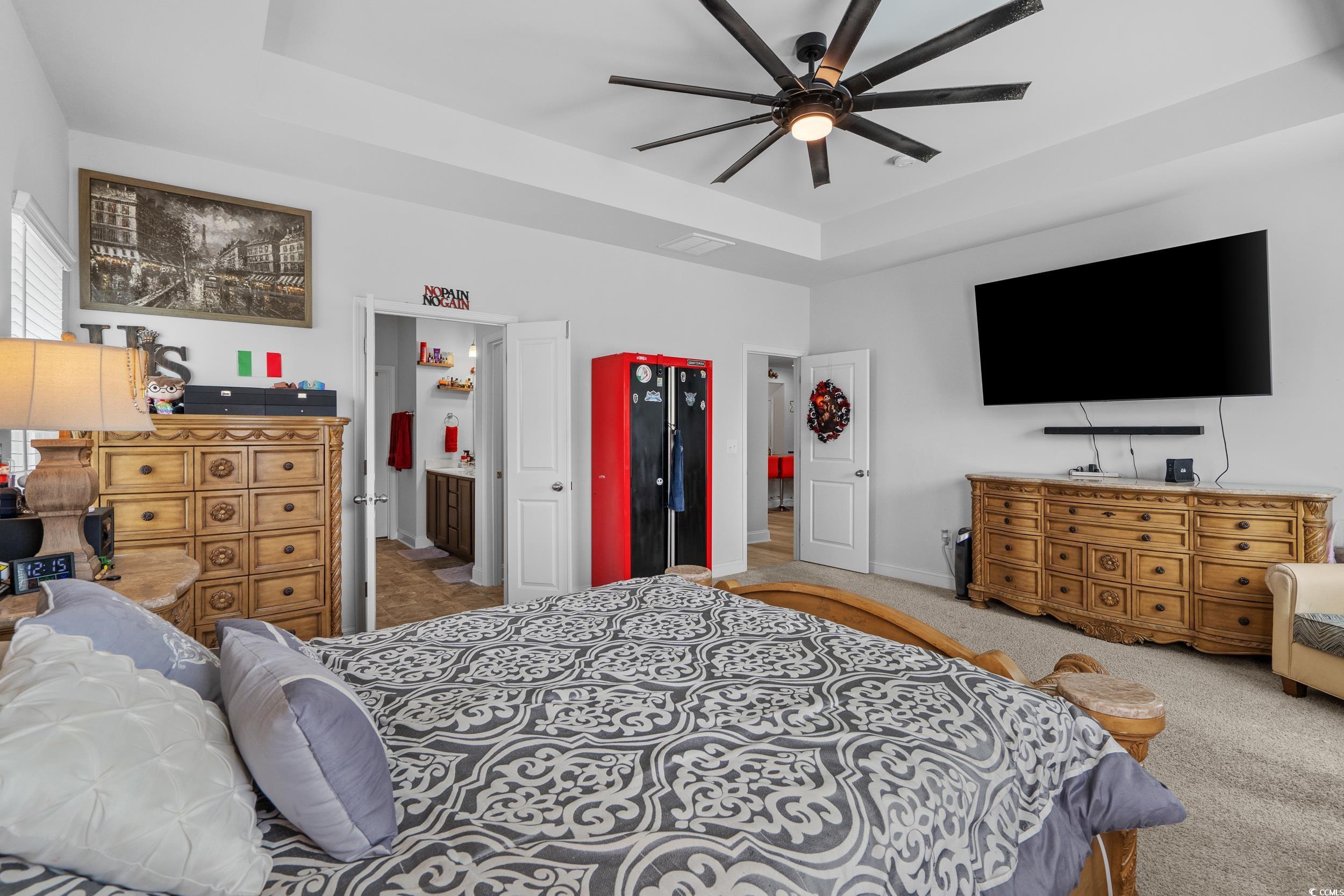 2064 Hazlette Loop Conway, SC 29526 - Photo 25 of 39 Carpeted bedroom with ensuite bathroom, baseboards, a ceiling fan, and a raised ceiling