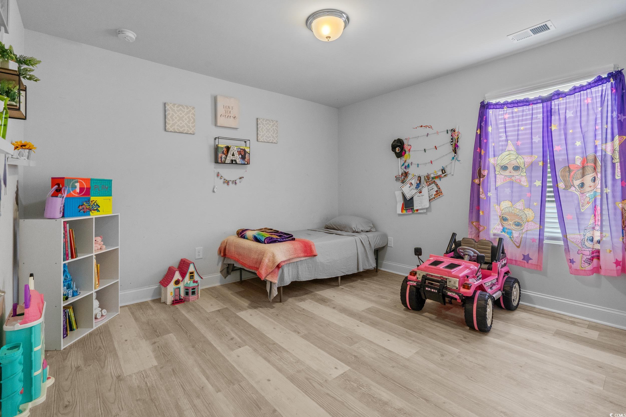 2064 Hazlette Loop Conway, SC 29526 - Photo 30 of 39 Bedroom featuring baseboards, visible vents, and wood finished floors