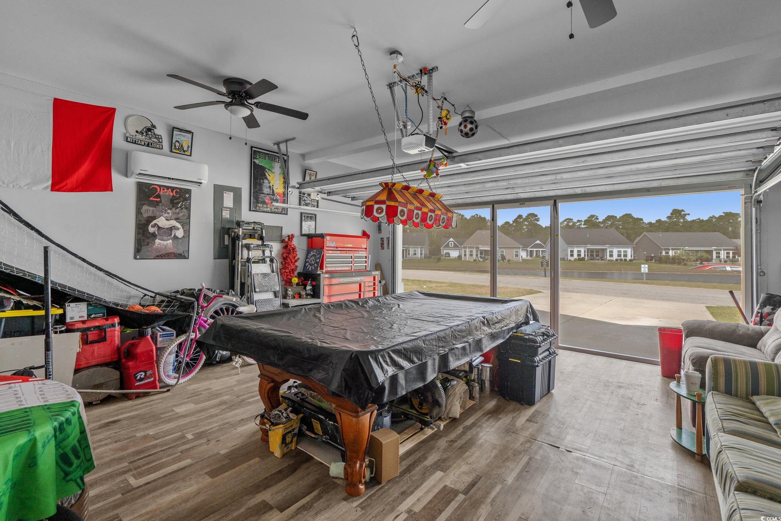 2064 Hazlette Loop Conway, SC 29526 - Photo 37 of 39 Recreation room featuring a wall mounted AC, pool table, a ceiling fan, wood finished floors, and a garage