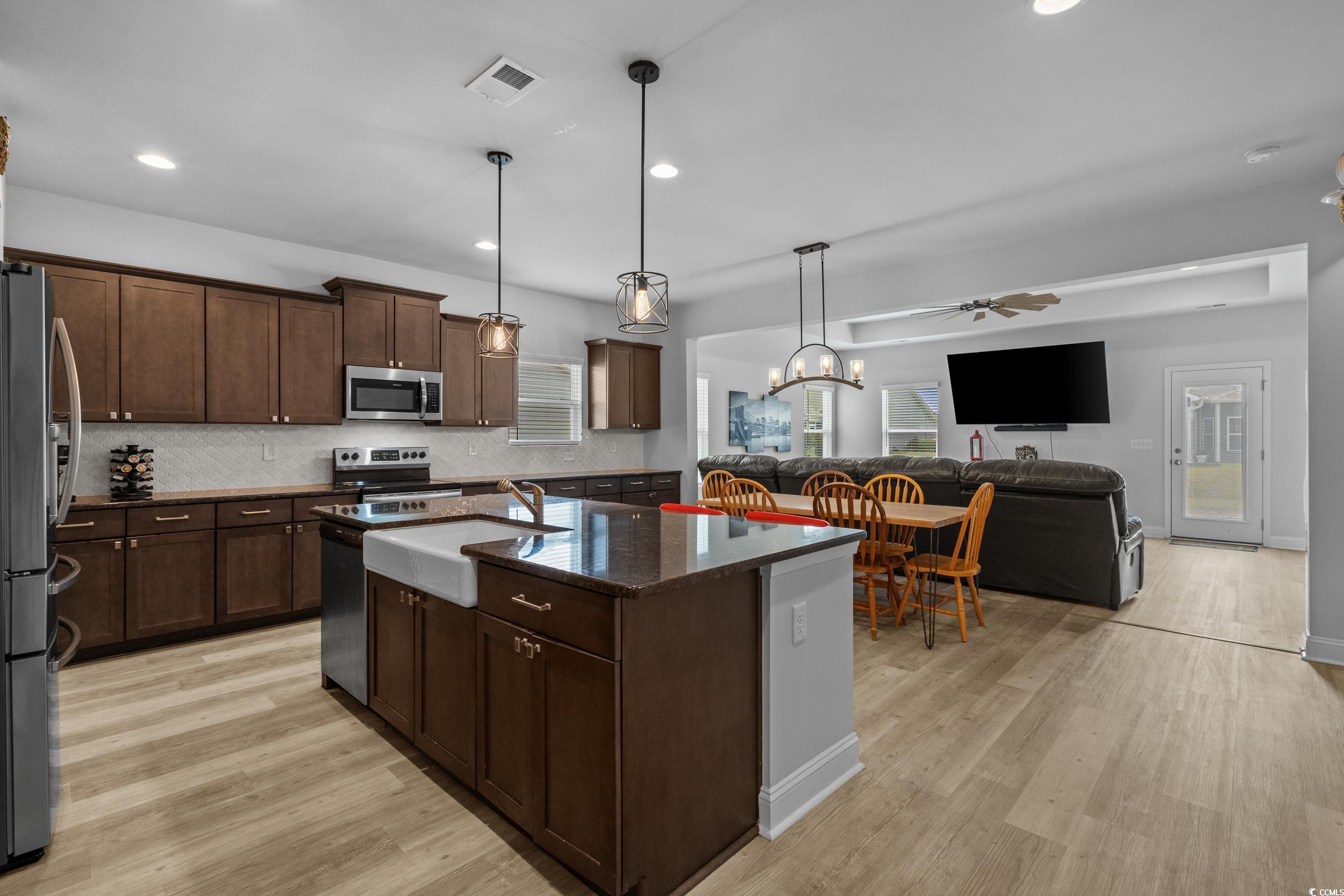 2064 Hazlette Loop Conway, SC 29526 - Photo 39 of 39 Kitchen with a sink, open floor plan, light wood-style flooring, stainless steel appliances, and visible vents