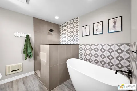 a bathroom with a bathtub and shower