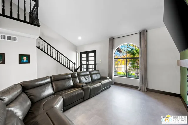 a living room with furniture and a gate
