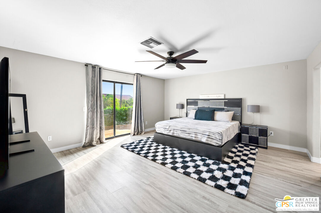 28220 Horizon Road Cathedral City, CA 92234 - Photo 8 of 40 a bedroom with a bed and a large window