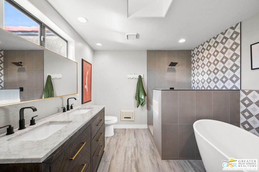 28220 Horizon Road Cathedral City, CA 92234 - Photo 9 of 40 a bathroom with a sink a toilet and a mirror