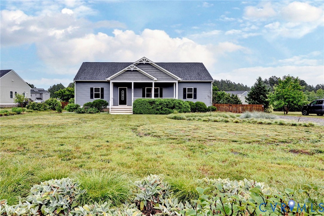 8904 Rock Cedar Road New Kent, VA 23124 - Photo 36 of 37 a front view of a house with a garden