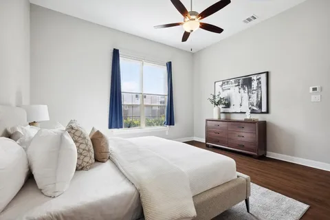 a bedroom with a large bed and a window