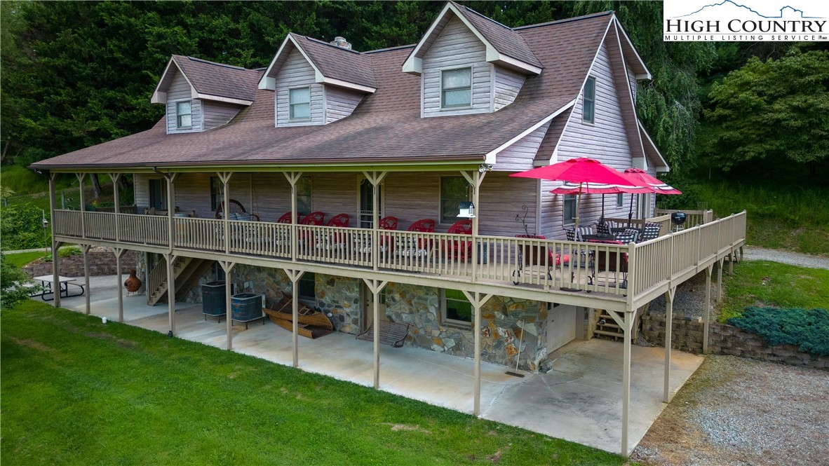 2161 River Bend Road Mouth Of Wilson, VA 24363 - Photo 33 of 47 a view of a house with a yard and balcony