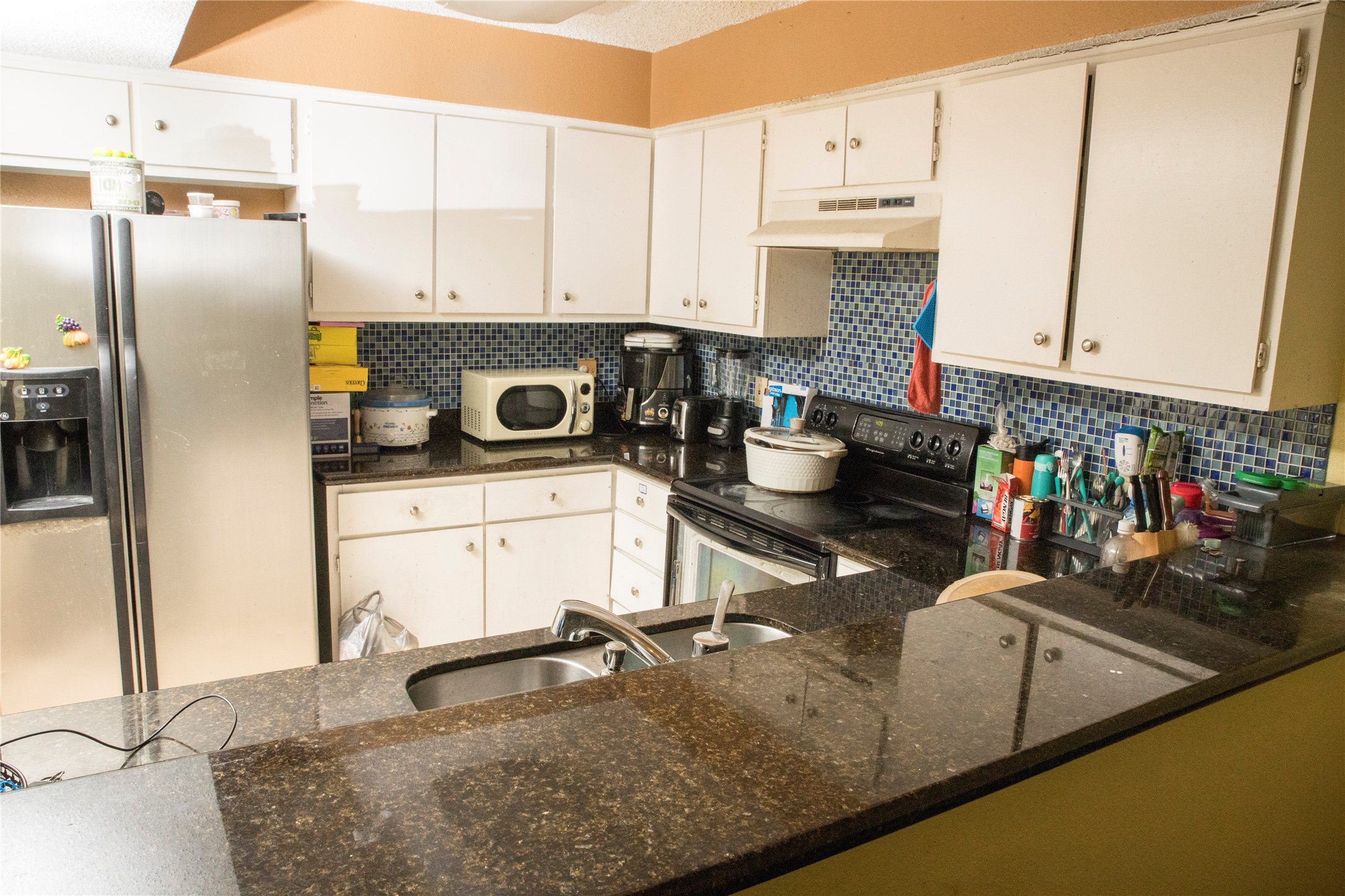 13005 Leader Street, Unit 563 Houston, TX 77072 - Photo 5 of 18 a kitchen with a sink a stove and a refrigerator