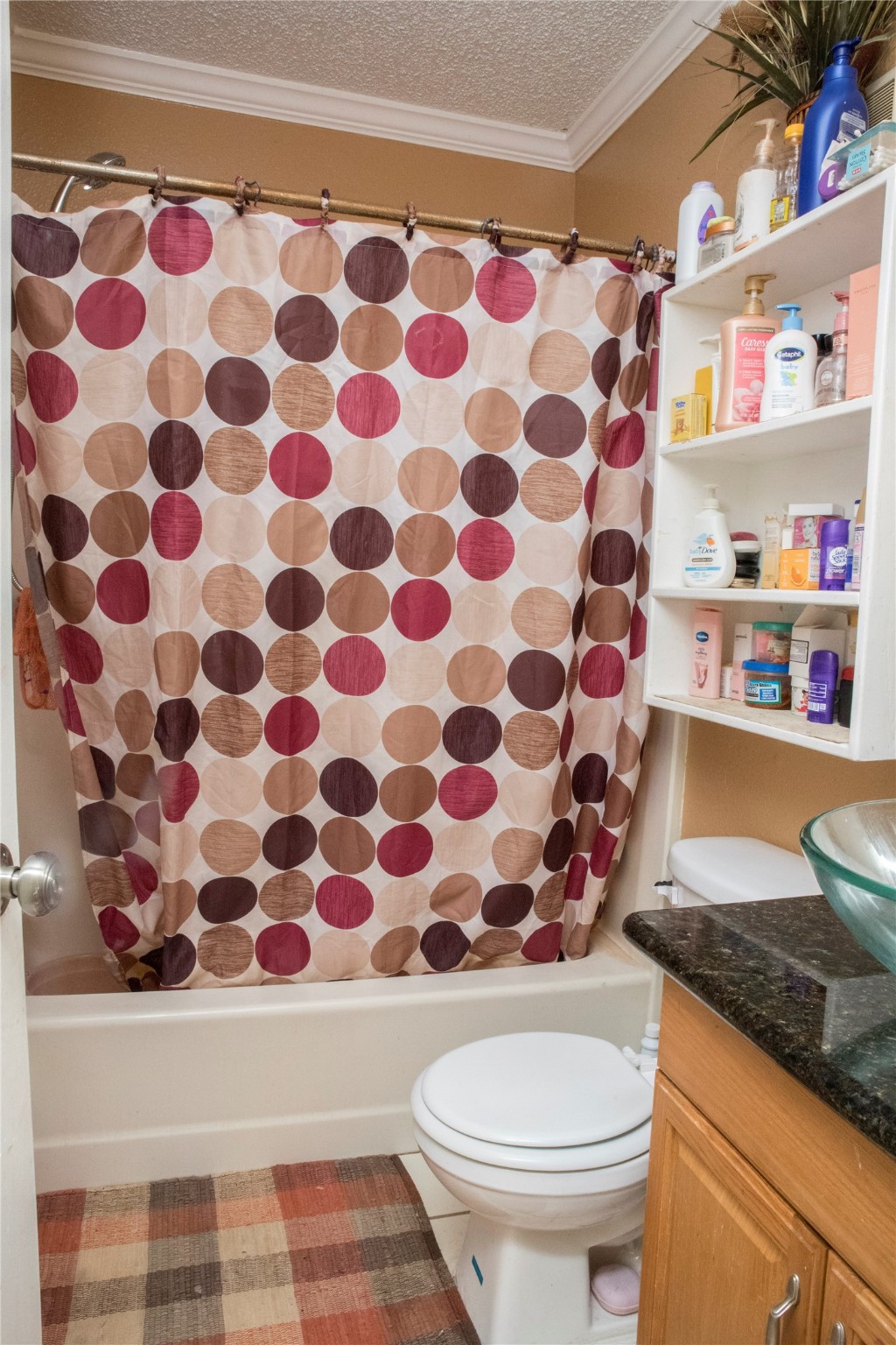 13005 Leader Street, Unit 563 Houston, TX 77072 - Photo 9 of 18 a bathroom with a granite countertop toilet and a sink