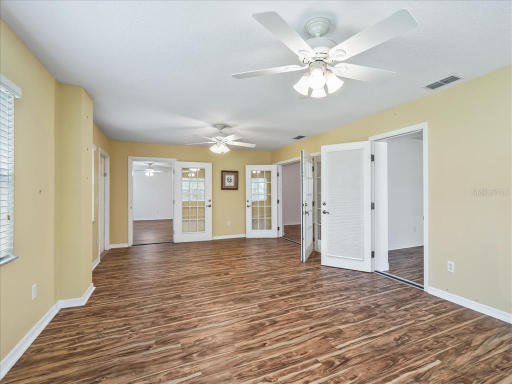 11025 Southeast 174th Loop Summerfield, FL 34491 - Photo 12 of 52 a view of an empty room with window and wooden floor
