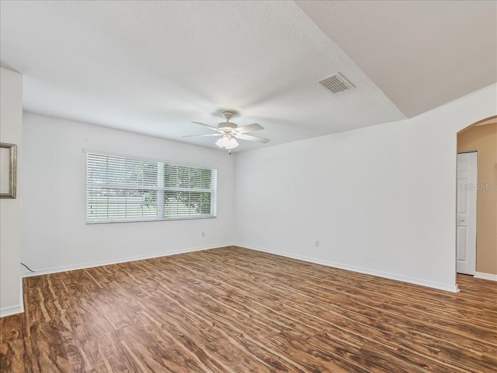 11025 Southeast 174th Loop Summerfield, FL 34491 - Photo 15 of 52 a view of an empty room with wooden floor and a window