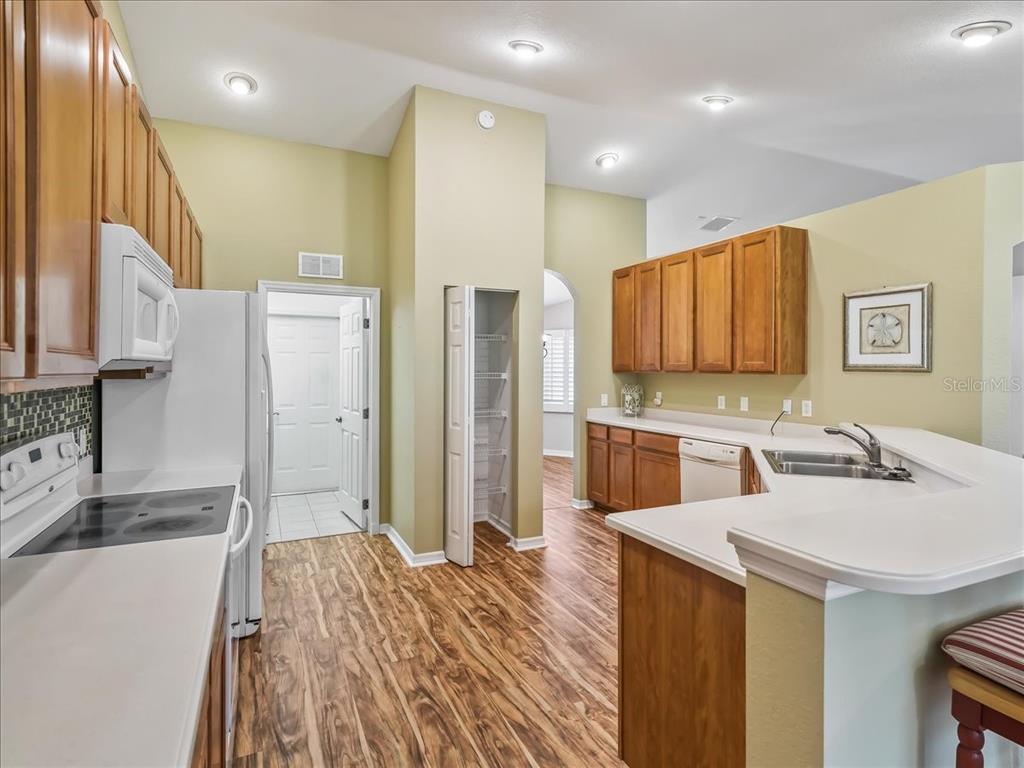 11025 Southeast 174th Loop Summerfield, FL 34491 - Photo 17 of 52 a kitchen with stainless steel appliances kitchen island granite countertop a refrigerator and a sink